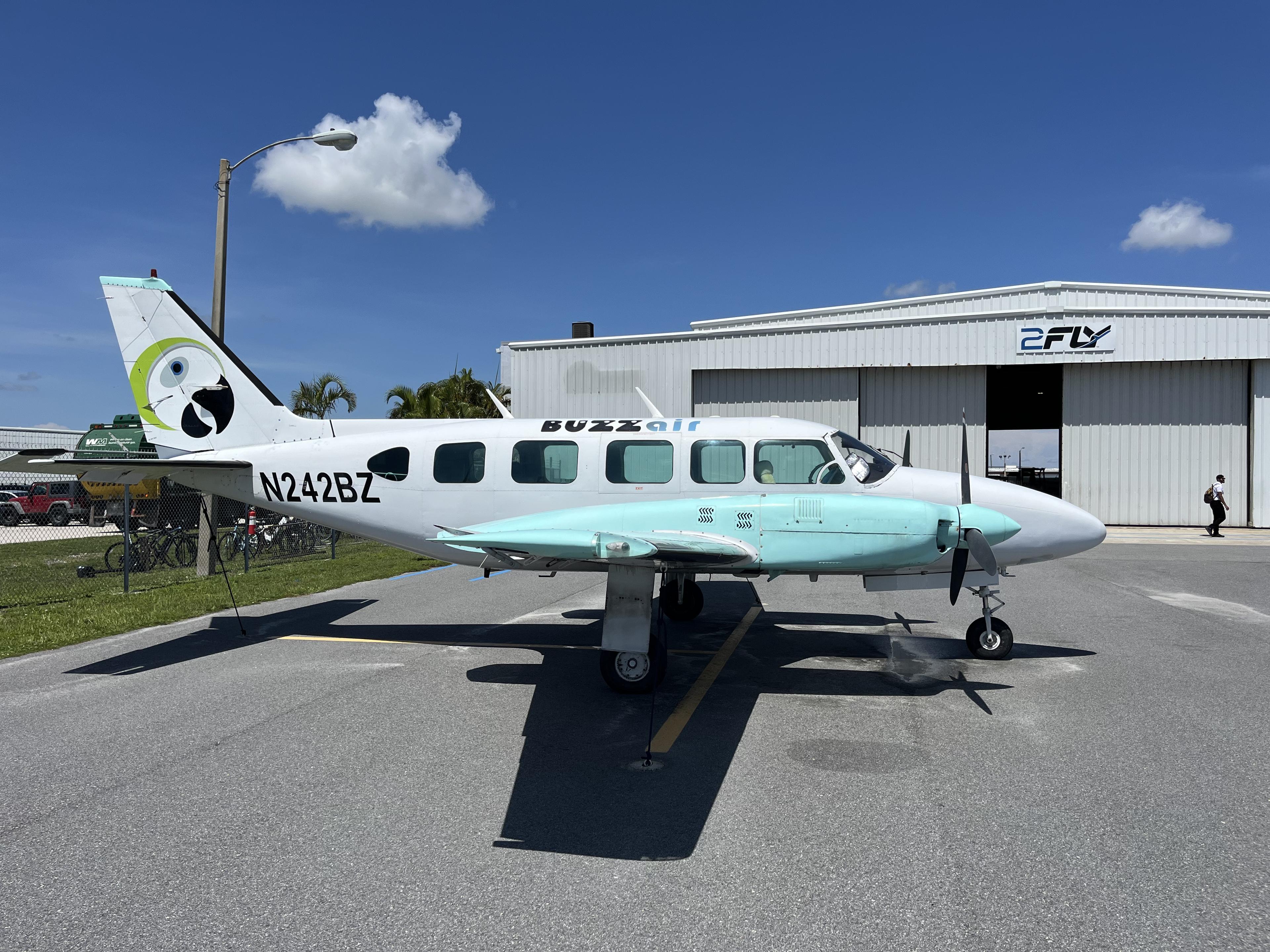 Two people shaking hands near a general aviation aircraft on the ramp